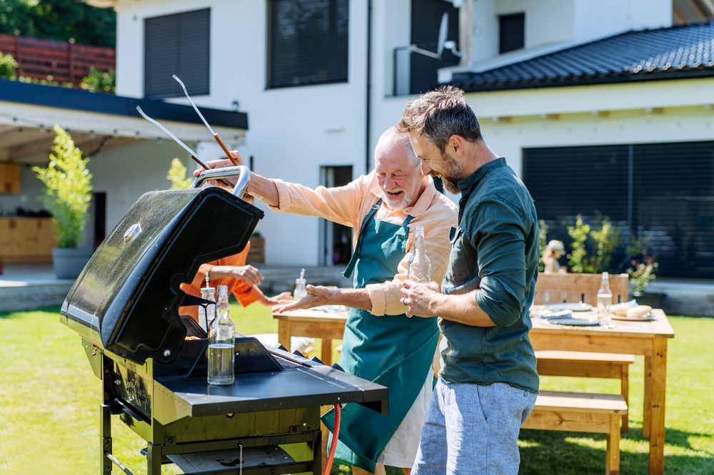 father and son grilling outdoors